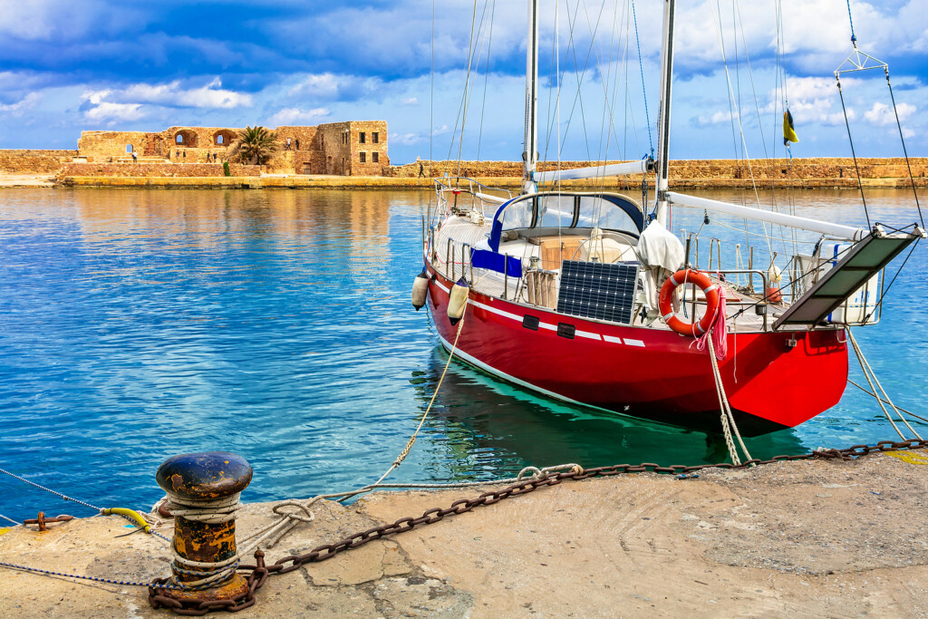 red sailing boat in old town of Chania, Crete islad, Greece